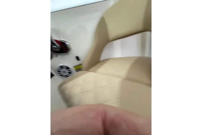 Slide: The Image of Interior of 2022 Oceania 23WA boat, featuring beige seating and control panel. - 21