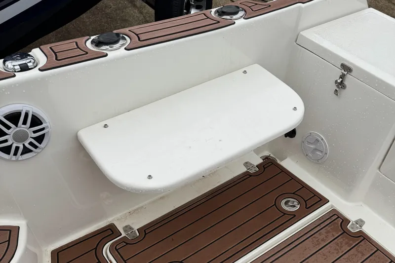 Slide: The Image of Oceania 23WA 2022 boat interior with white bench and wood-patterned flooring. - 5