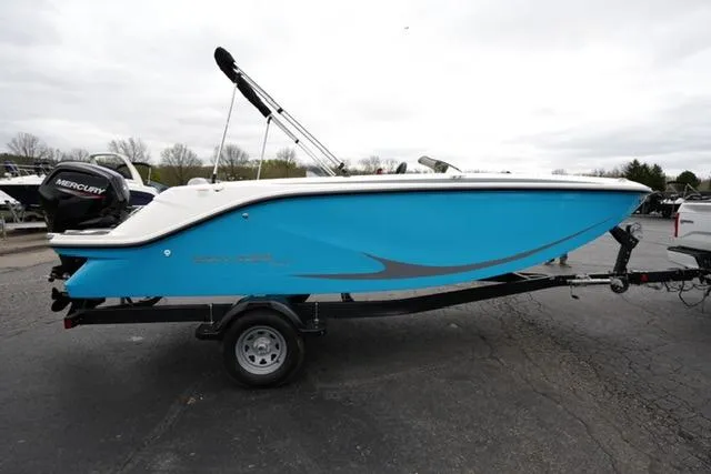 Slide: The Image of 2025 Bayliner Element M19 boat on trailer, blue hull, parked outdoors. - 3