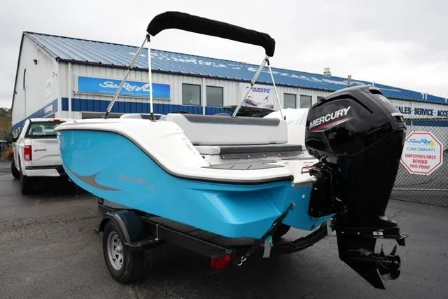 Slide: The Image of 2025 Bayliner Element M19 boat with Mercury engine, parked outside dealership. - 6
