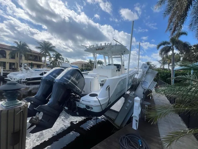 Slide: The Image of 2018 Robalo R302 boat with Yamaha engines docked under a cloudy sky. - 16