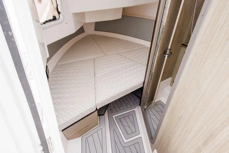 Slide: The Image of 2026 Solara S 310 SB cabin interior with cushioned bed and modern flooring. - 13