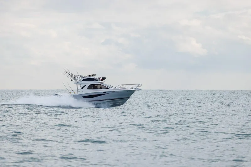 Slide: The Image of 2026 Solara S 310 SB boat cruising on open water under cloudy skies. - 3