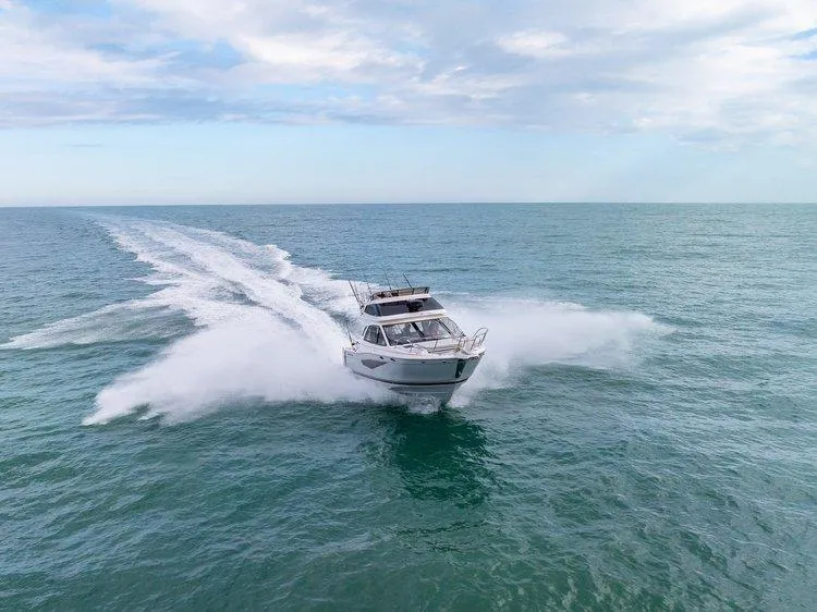 Slide: The Image of 2026 Solara S 310 SB boat cruising swiftly on open sea under cloudy sky. - 4