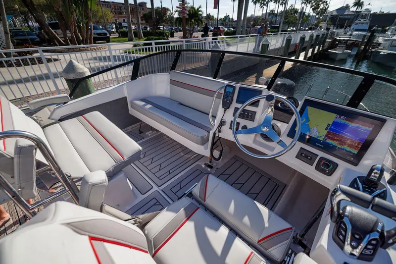 Slide: The Image of 2026 Solara S 310 SB boat interior with modern dashboard and seating at marina. - 5
