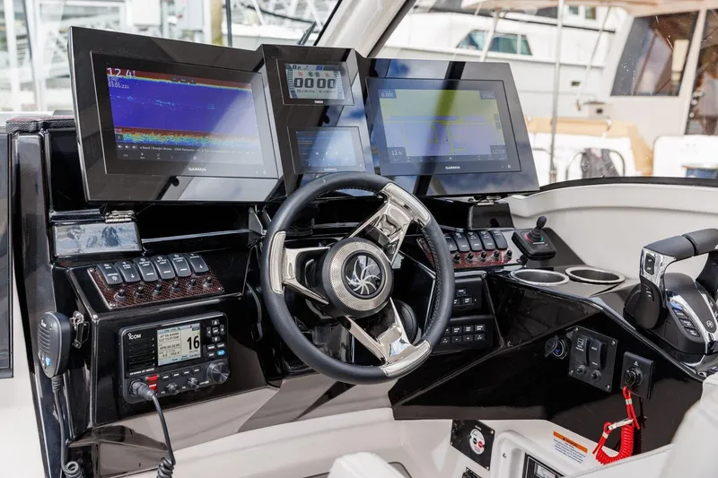 Slide: The Image of Helm of 2026 Solara S 310 SB boat with advanced navigation displays and controls. - 9