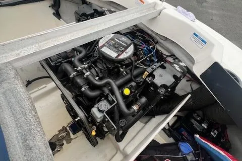Slide: The Image of Engine compartment of a 2011 Sea Ray 185 Sport boat, showcasing detailed mechanical components. - 10