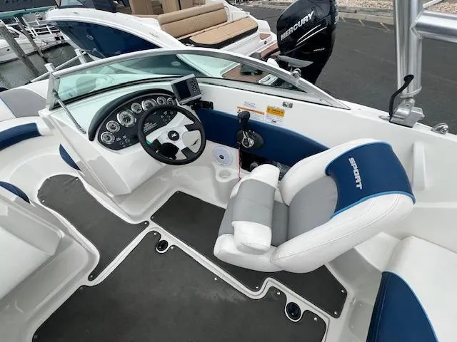 Slide: The Image of 2011 Sea Ray 185 Sport boat interior with steering wheel and dashboard controls. - 2