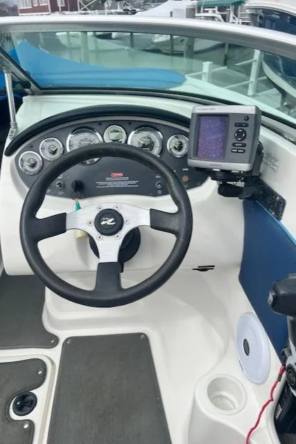 Slide: The Image of 2011 Sea Ray 185 Sport dashboard with steering wheel and navigation system. - 3