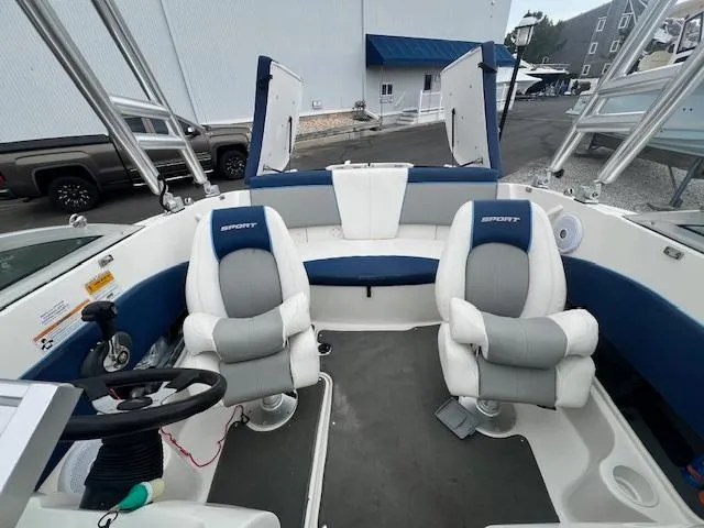 Slide: The Image of 2011 Sea Ray 185 Sport boat interior with two cushioned seats and steering wheel. - 5