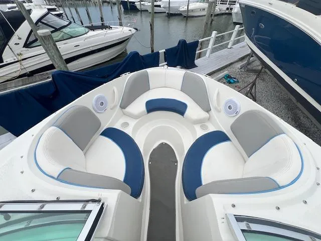 Slide: The Image of 2011 Sea Ray 185 Sport boat with spacious seating and modern design at a marina. - 8