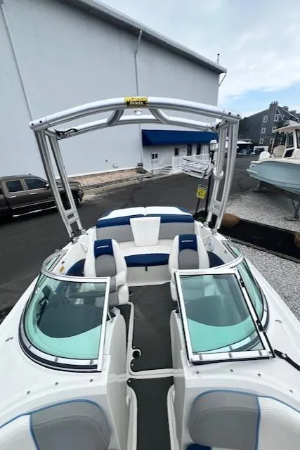Slide: The Image of 2011 Sea Ray 185 Sport boat with blue and white interior, docked outdoors. - 9