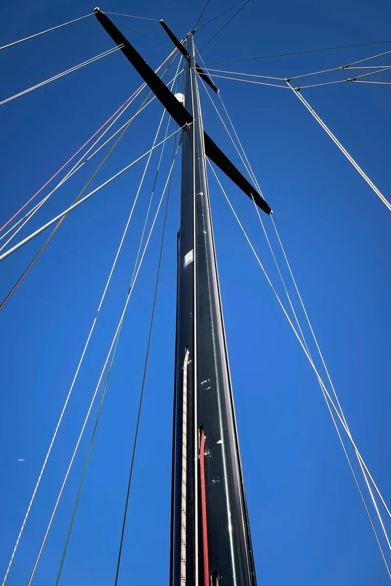 Slide: The Image of Tall mast of a 1982 Baltic 42 sailboat against a clear blue sky. - 10