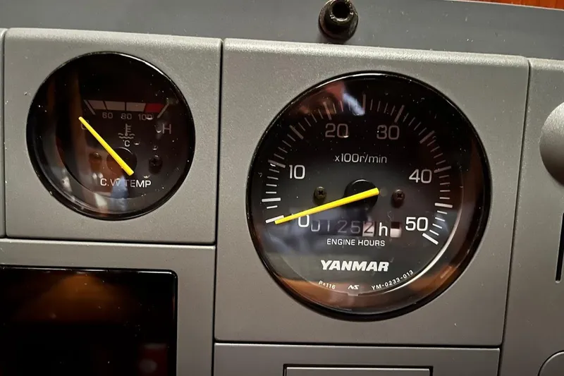 Slide: The Image of Dashboard gauges of a 1982 Baltic 42, showing engine RPM and coolant temperature. - 11