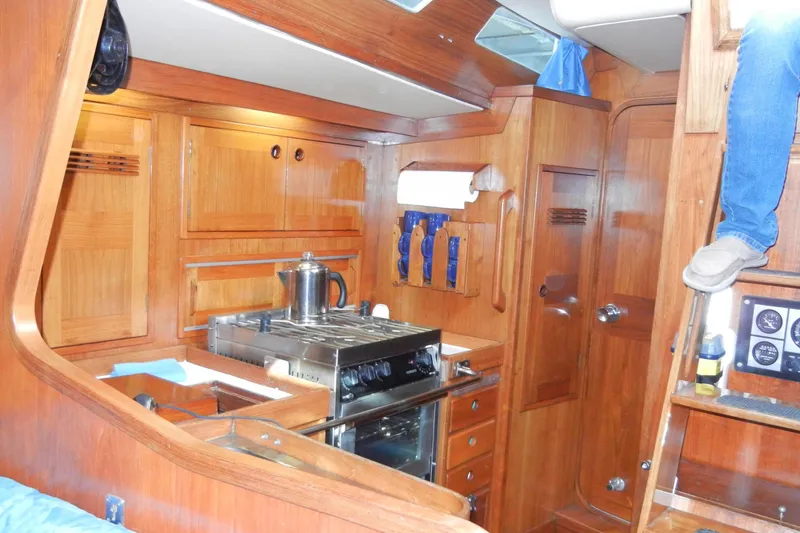 Slide: The Image of Interior of a 1982 Baltic 42 yacht with wooden cabinetry and kitchen area. - 14