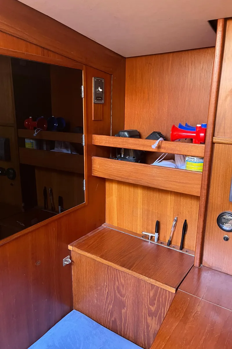 Slide: The Image of Interior of a 1982 Baltic 42 yacht with wooden shelves and storage. - 20