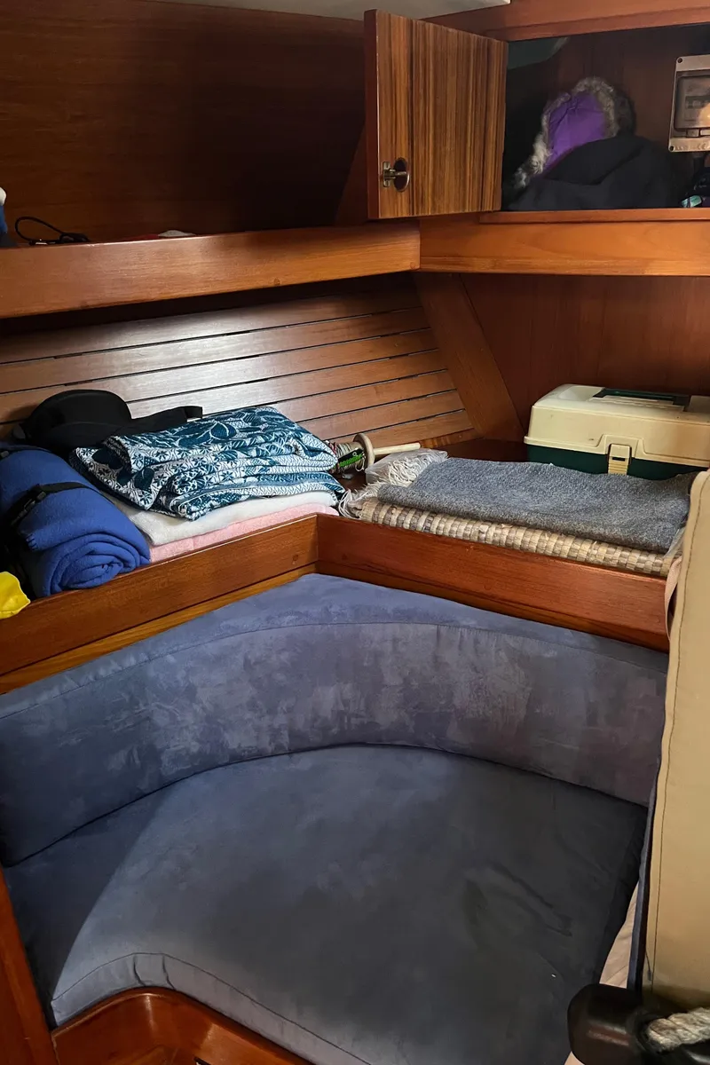 Slide: The Image of Cozy cabin interior of 1982 Baltic 42 sailboat with wooden finish and bedding. - 24