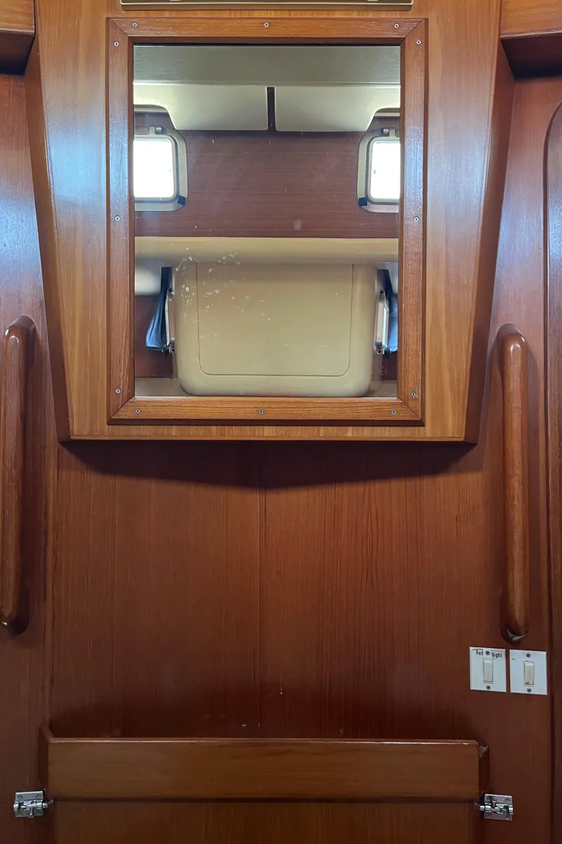 Slide: The Image of Interior of 1982 Baltic 42 yacht with wooden cabinetry and mirror. - 32