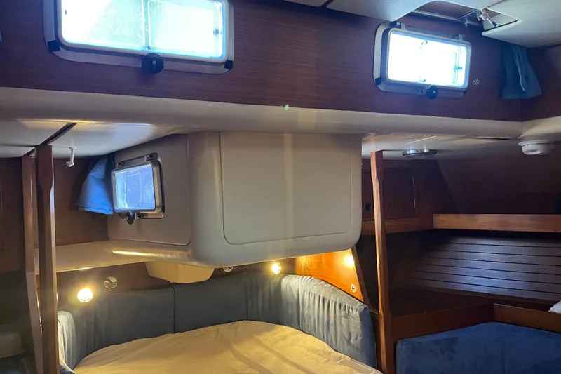 Slide: The Image of Cozy cabin interior of a 1982 Baltic 42 sailboat with wooden finishes and blue upholstery. - 33