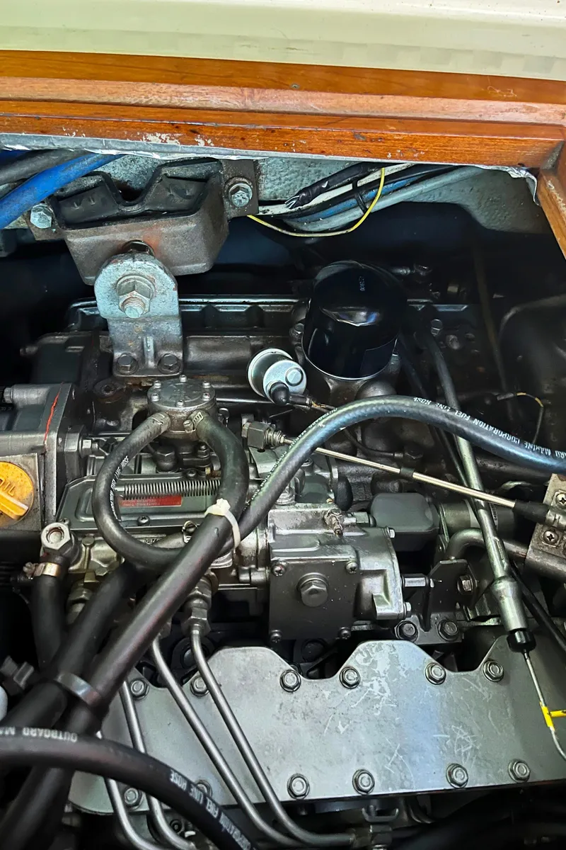 Slide: The Image of Engine compartment of a 1982 Baltic 42 sailboat, showcasing mechanical components and wiring. - 34