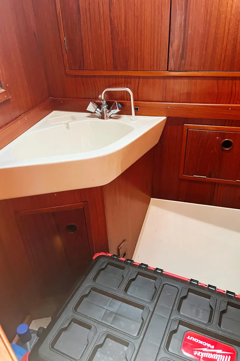 Slide: The Image of Wood-paneled bathroom in 1982 Baltic 42 yacht with sink and storage. - 39