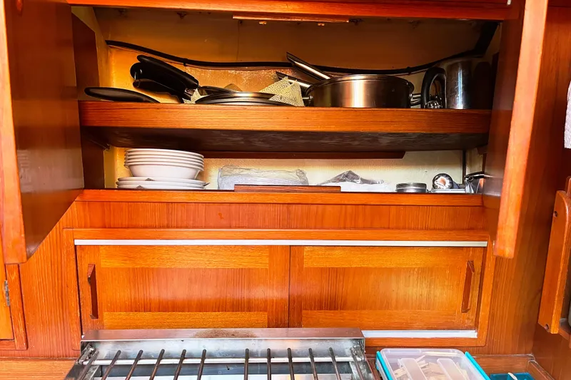 Slide: The Image of Wooden kitchen shelves with dishes and cookware on a 1982 Baltic 42 yacht. - 41