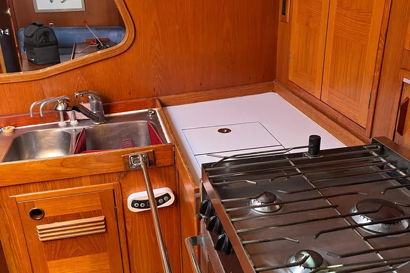 Slide: The Image of Wooden kitchen interior of 1982 Baltic 42 yacht with sink and stove. - 44