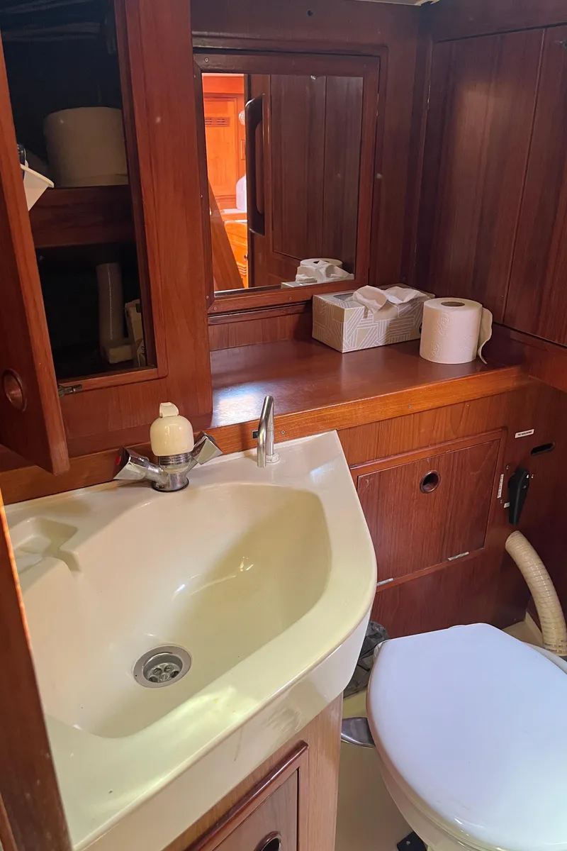 Slide: The Image of Bathroom interior of a 1982 Baltic 42 yacht with wooden cabinetry and sink. - 47
