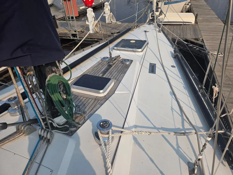 Slide: The Image of Deck view of a 1982 Baltic 42 sailboat docked at a marina. - 49