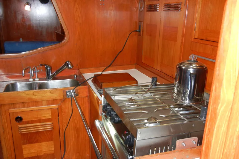 Slide: The Image of Wooden kitchen interior of 1982 Baltic 42 yacht with sink and stove. - 15