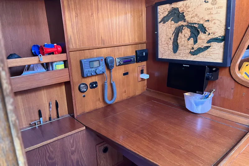 Slide: The Image of Cozy cabin interior of 1982 Baltic 42 sailboat with wooden finish and blue cushions. - 21