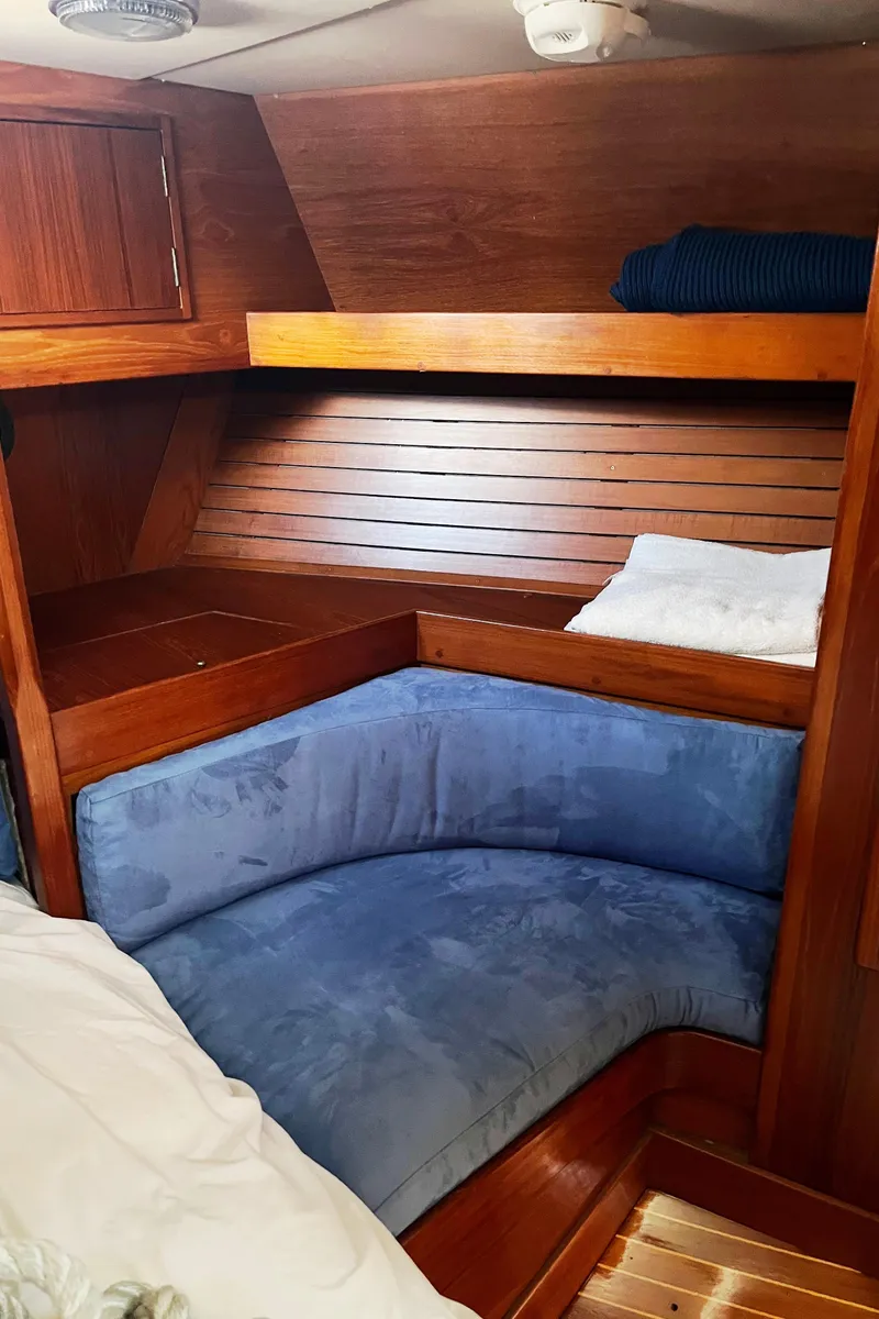 Slide: The Image of Deck view of a 1982 Baltic 42 sailboat docked at a marina. - 28