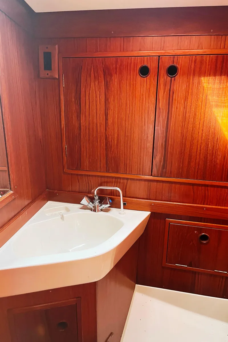 Slide: The Image of Engine compartment of a 1982 Baltic 42 sailboat, showcasing mechanical components and wiring. - 38