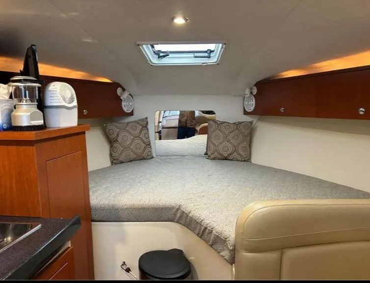 Slide: The Image of Interior cabin of 2005 Pro-Line 33 Express boat with cozy bed and modern amenities. - 3