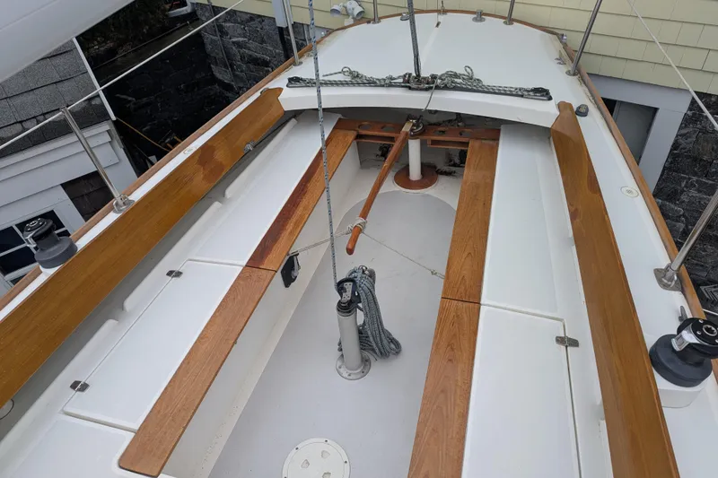 Slide: The Image of 2012 Alerion Express 28 sailboat cockpit with wooden trim and clean deck layout. - 12