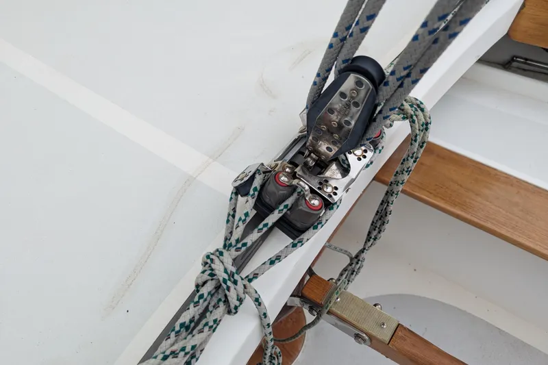 Slide: The Image of Sailing rigging on a 2012 Alerion Express 28 boat, featuring ropes and pulleys. - 25