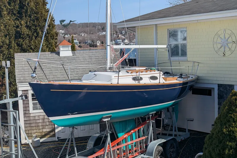 Slide: The Image of Alerion Express 28 sailboat, 2012 model, on trailer beside a house. - 3