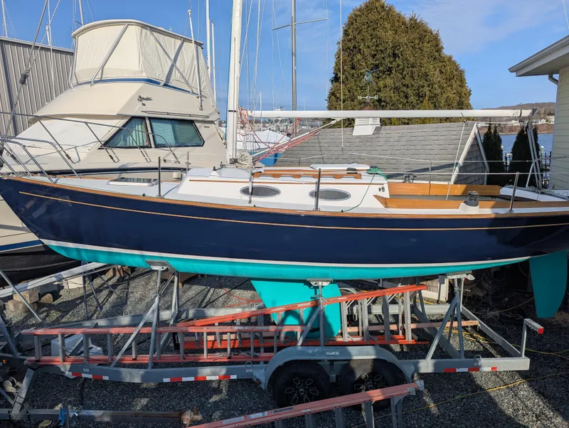 Slide: The Image of Alerion Express 28 sailboat, 2012 model, on a trailer in a marina setting. - 6