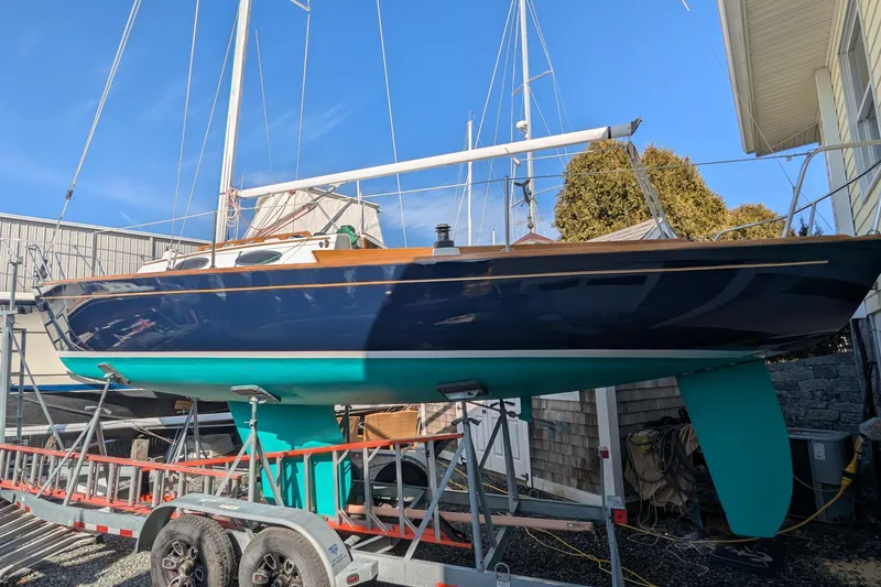 Slide: The Image of Alerion Express 28 sailboat, 2012 model, on a trailer in a boatyard. - 8