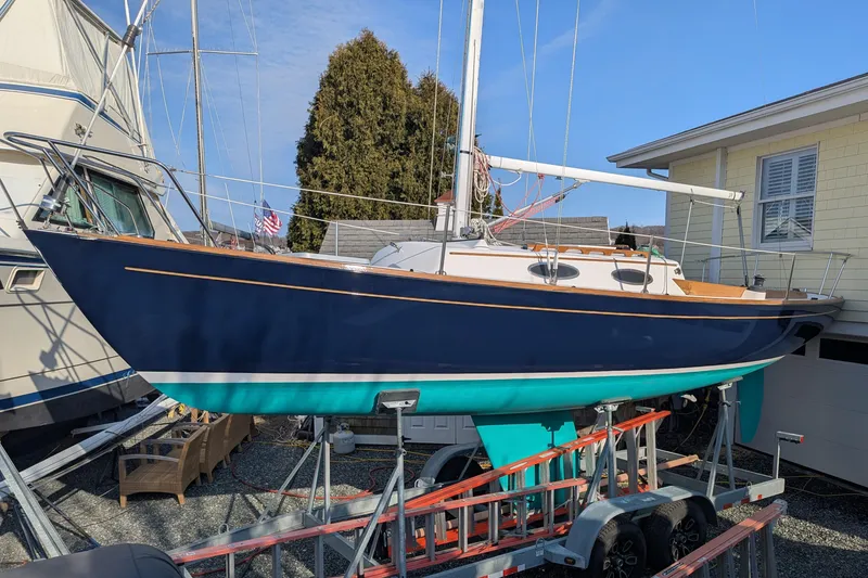 Slide: The Image of Alerion Express 28 sailboat, 2012 model, on a trailer in a boatyard. - 9