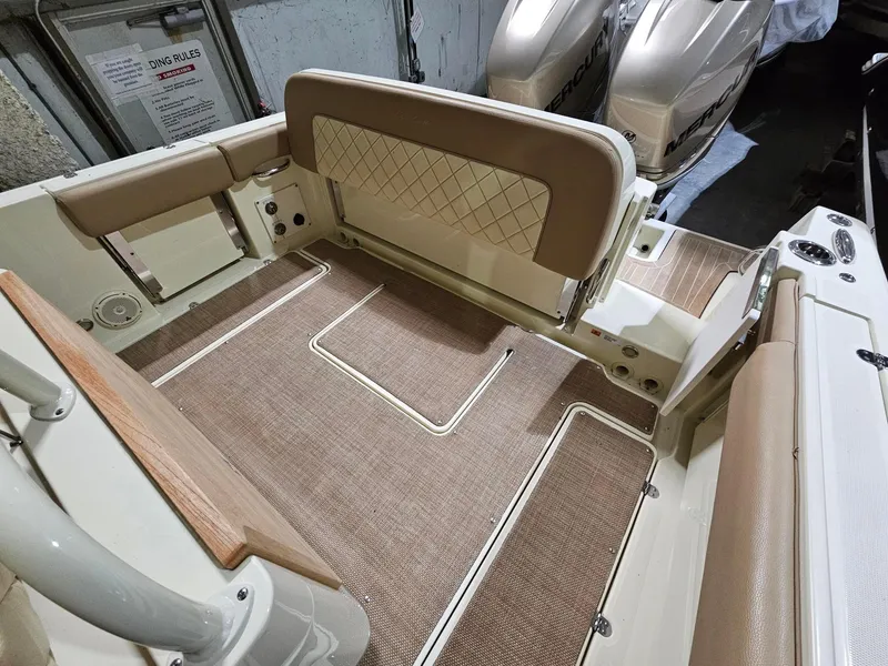 Slide: The Image of 2018 Chris-Craft 30 Catalina boat interior with beige seating and flooring. - 11