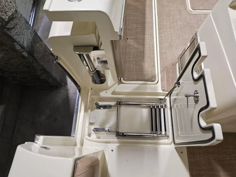 Slide: The Image of 2018 Chris-Craft 30 Catalina boat interior with foldable ladder and beige flooring. - 15