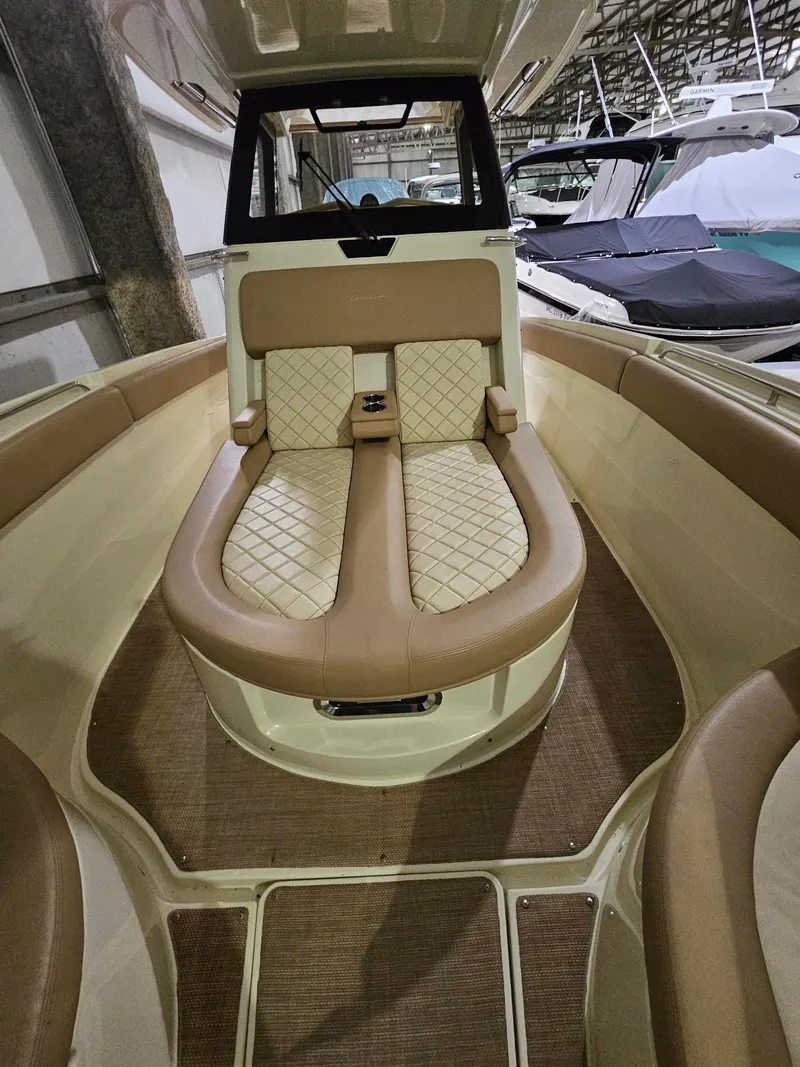 Slide: The Image of 2018 Chris-Craft 30 Catalina interior with beige seating and diamond stitching. - 17