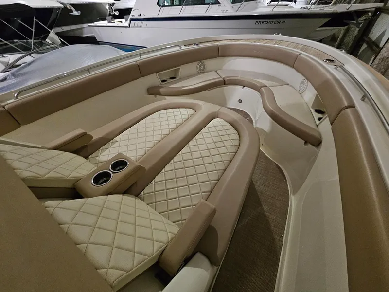 Slide: The Image of Luxurious interior of 2018 Chris-Craft 30 Catalina boat with beige quilted seating. - 18