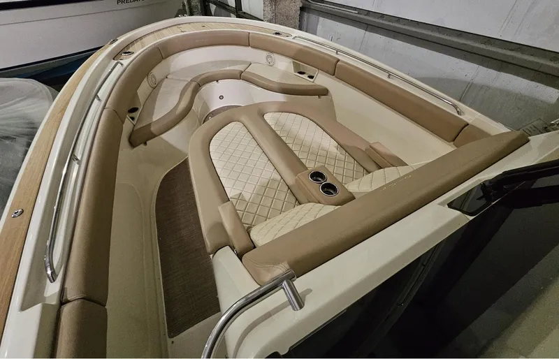 Slide: The Image of 2018 Chris-Craft 30 Catalina boat interior with beige seating and cup holders. - 19