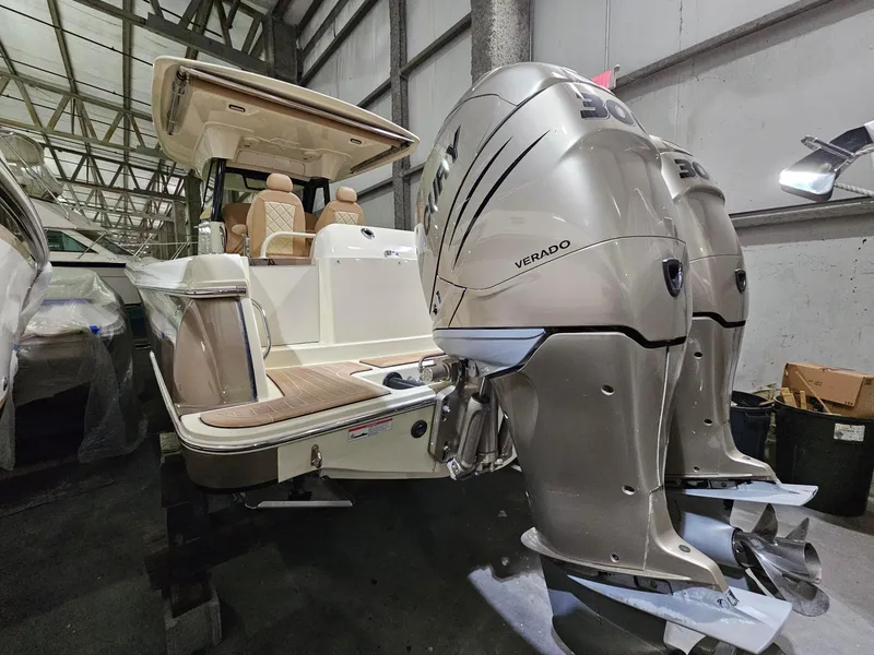 Slide: The Image of 2018 Chris-Craft 30 Catalina with dual Mercury Verado engines in a storage facility. - 2