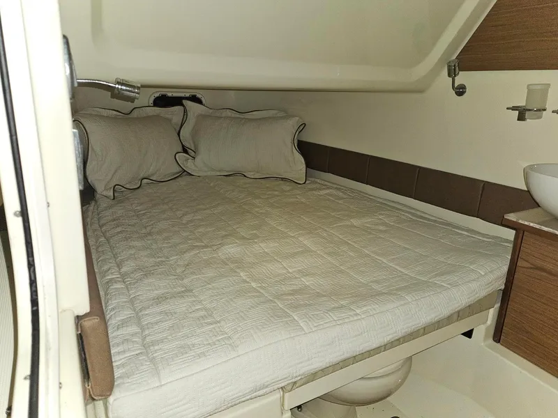 Slide: The Image of 2018 Chris-Craft 30 Catalina cabin interior with bed and pillows. - 20