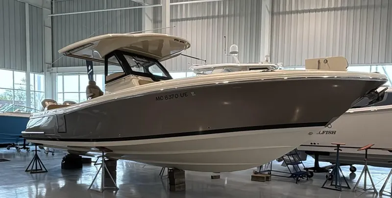Slide: The Image of 2018 Chris-Craft 30 Catalina boat displayed indoors on stands. - 21