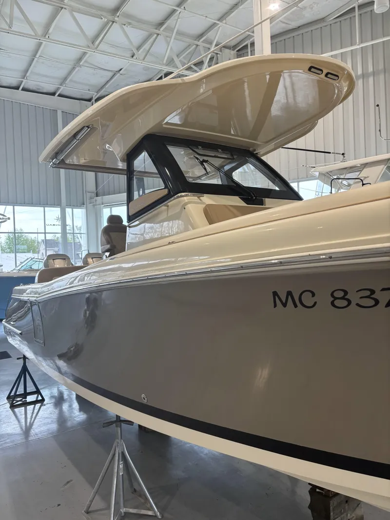 Slide: The Image of 2018 Chris-Craft 30 Catalina boat displayed indoors on stands. - 22