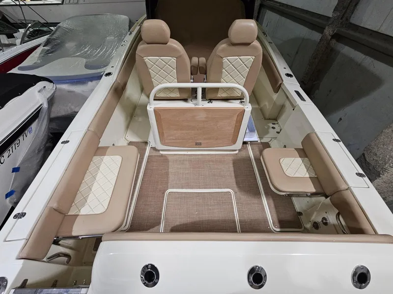 Slide: The Image of 2018 Chris-Craft 30 Catalina boat interior with beige seating and diamond-patterned upholstery. - 3
